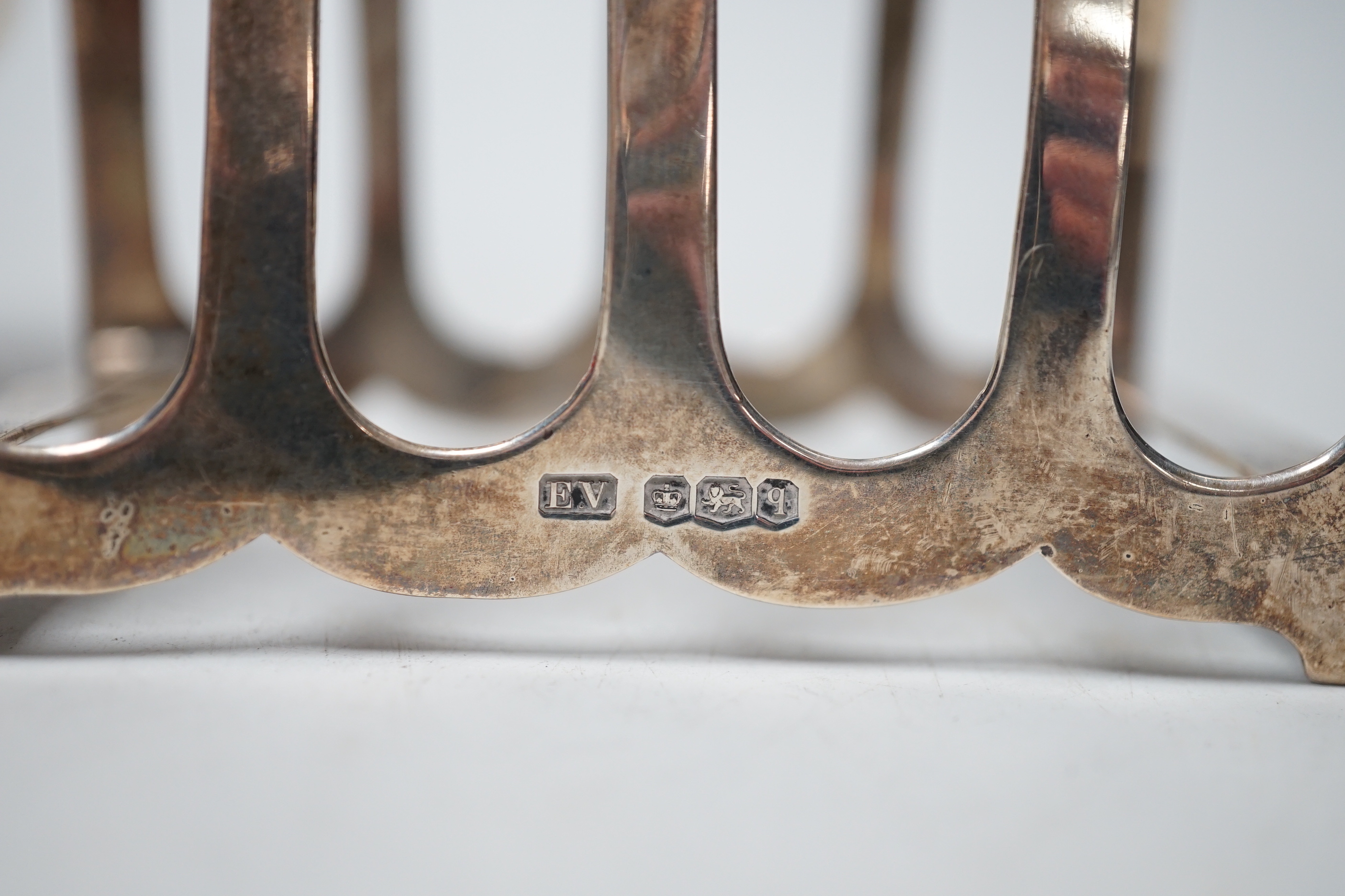 A modern silver sugar caster, 16.5cm and a George V silver toast rack, 8.7oz.